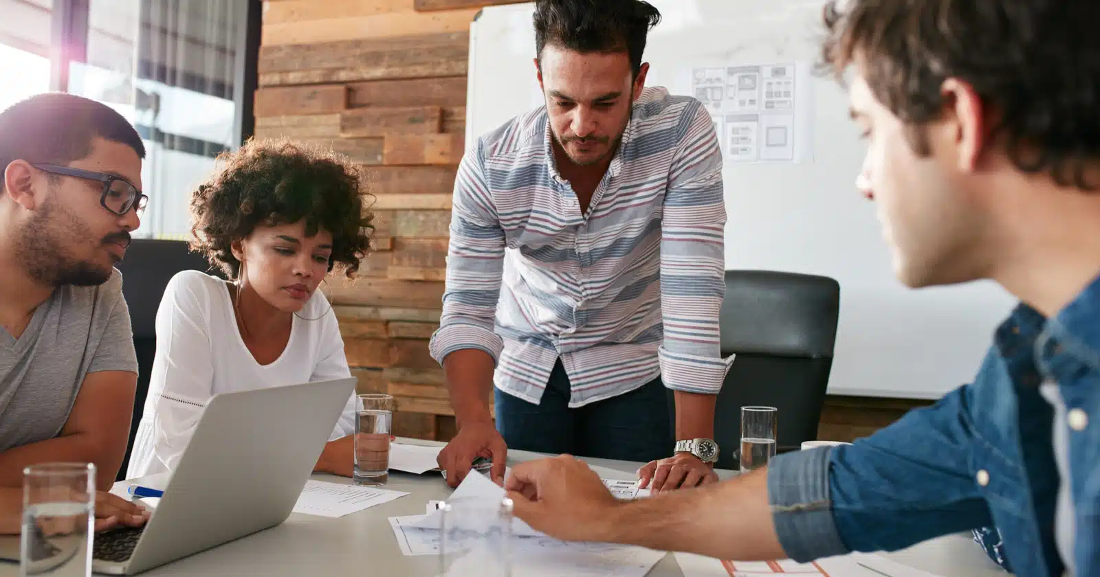 A diverse group of professionals analyzing SEO data during a meeting.